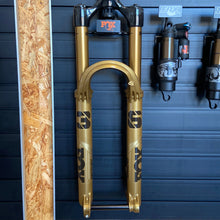 Laden Sie das Bild in den Galerie-Viewer, FOX 36 Float Factory GRIP X suspension fork in limited edition Podium Gold, featuring 29-inch wheel compatibility, 160 mm travel, Kashima-coated stanchions, and robust magnesium lowers. The fork displays distinctive gold finish, black decals, and precision adjustment dials on the crown, designed for aggressive all-mountain and enduro riding